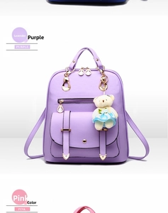 Detail of taro purple fashion backpack with gold hardware and a cute white bear charm