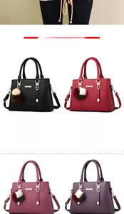 Detailed view of fashion tote bags in multiple colors with plush pom pom charms