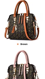 Close-up of patterned faux leather handbags with cat tassels in tan and pink colors