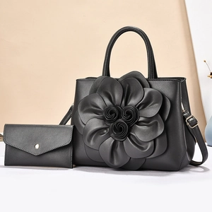 Chic black handbag set with 3D leather flower detail and matching envelope clutch