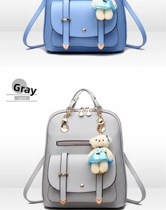 Close-up of PU leather backpack with a plush bear charm and heart metallic details