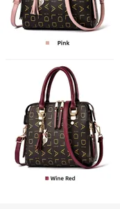 Close-up of pink and wine red leather handbags with gold letter prints and tassel charm