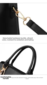Detail of black lychee grain texture with gold metal buckle and ergonomic round handle