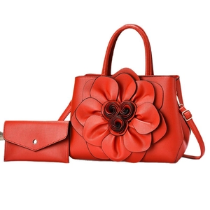Fashionable red tote bag set with large 3D floral accents and matching clutch purse