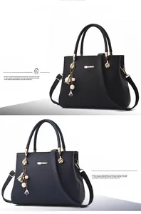 Detailed showcase of black and royal blue pebbled leather handbags with elegant charms.