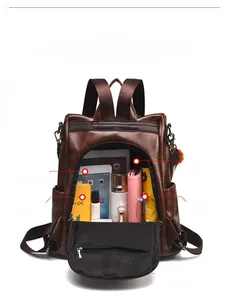Detail view of brown leather backpack interior showing large capacity for iPad and umbrella