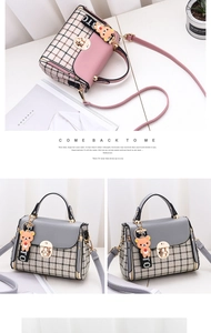 Detail of grid patterned crossbody bags with cute bear charm and metal ring buckle