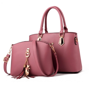 Women's pink tote and crossbody bag set with golden hardware and cat pendant charm