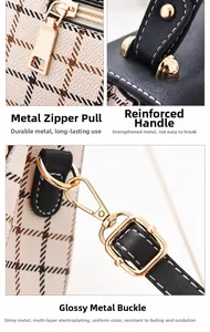 Detailed macro view of gold-plated hardware zipper and reinforced black leather handle