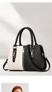 Detailed view of bicolor panel tote bag featuring quilted texture and gold hardware details