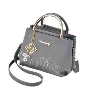 Dark grey leather handbag with grey floral embroidery and golden semi-circular handles