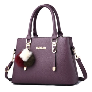 Purple faux leather handbag with lychee texture and colorful pompom charm