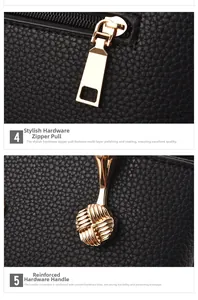 Detail of gold metal zipper and reinforced handle hardware on black litchi grain leather bag