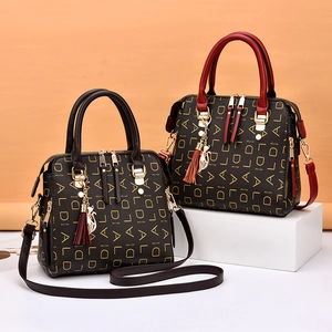 Fashionable brown monogram crossbody bags with cat pendants and top handles for women