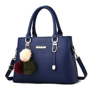 Navy blue faux leather handbag with litchi texture and colorful plush ball charm