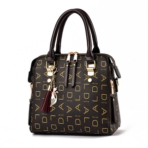 Brown textured leather crossbody bag with golden DIALD pattern and cat charm