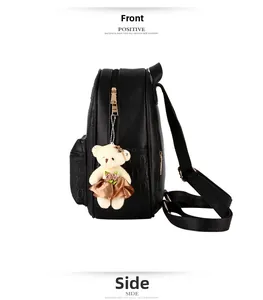 Detail view of black PU leather backpack with circular embossed pattern and gold zippers