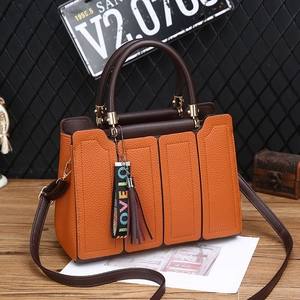 Sac à main orange et marron avec pompon doré et détails de broderie LOVE