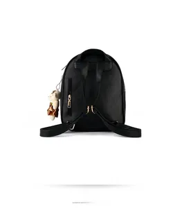 Back view of black pebble leather backpack with gold zippers and a bear pendant