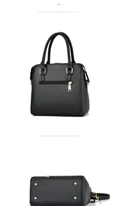Rear view of black embroidered handbag with gold zippers and protective metal base feet