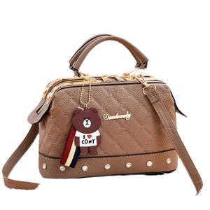 Brown quilted leather satchel with metal hardware and adjustable shoulder strap