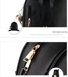 Detail of rear anti-theft zipper pocket on black Saffiano leather backpack with gold hardware