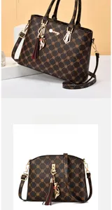 Detailed set of large dark brown patterned tote and mini shell crossbody bag with charms