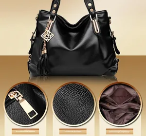 Detail view of black pebble leather tote featuring gold hardware and spacious interior