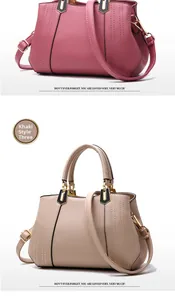 Close-up of litchi grain faux leather textures and golden hardware on women's handbag