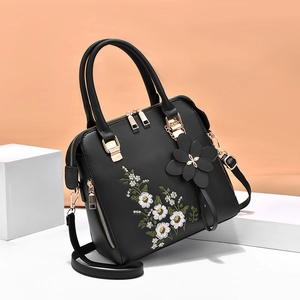 Elegant black embroidered handbag for women with floral pattern and golden hardware details