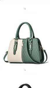 Detail of color-block tote bag with quilted pattern, matching handles and metal hardware