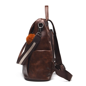 Deep brown retro faux leather backpack with plush pendant and striped woven strap
