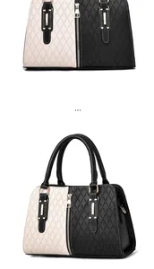 Detail of black and white color-block tote bag with quilted texture and gold hardware
