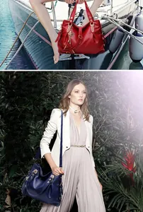 Close-up of red and navy large leather tote bags with tassels and gold hardware details