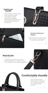 Detail view of black litchi pattern handbag with gold hardware and reinforced stitching
