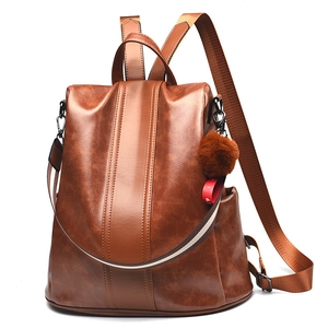 Caramel brown faux leather anti-theft backpack for women with pompom and side pockets