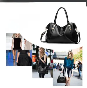 Close-up of black lychee grain leather handbag with gold hardware and shoulder strap