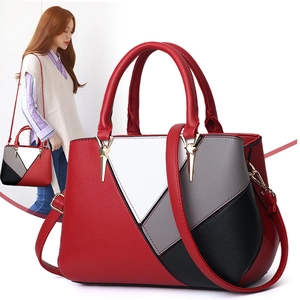 Chic geometric patchwork handbag in red grey and black with gold charm pendant