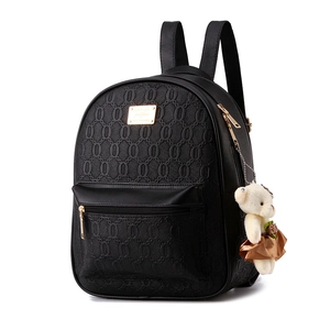 Chic black faux leather backpack with embossed pattern and cute bear charm accessory
