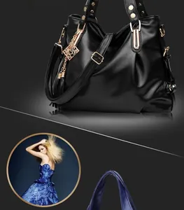 Close-up of black pleated leather handbag with gold metal rings and rivet detailing