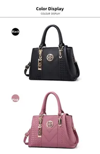 Detail view of stylish embroidered handbags in black and dusty pink with gold hardware