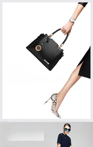Detail of black lychee grain leather handbag featuring elegant gold hardware and logo