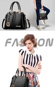 Detail of a black leather bucket bag with gold hardware and stylish shoulder strap