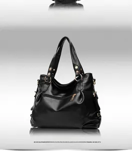 Detail of black pebbled leather handbag featuring a rear zipper pocket and gold metal rivets