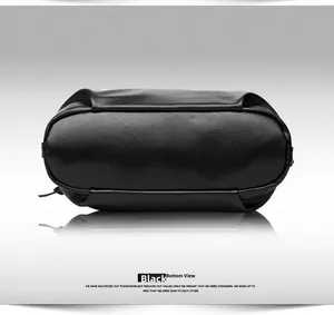 Detailed bottom view of black litchi grain leather handbag showing high-quality stitching