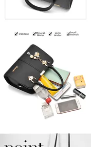 Detailed interior of black lychee leather bag showing large capacity for iPad and essentials