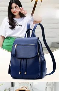 Detail of dark blue PU leather backpack featuring drawstring closure and gold hardware
