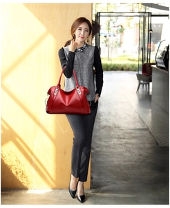 Deep red soft leather tote bag shown on a model for a realistic size comparison