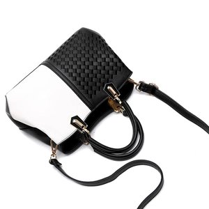 Chic black and white woven texture tote bag with gold hardware and adjustable strap