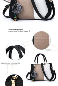 Detail of crocodile-textured faux leather handbag with plush ball charm and gold hardware